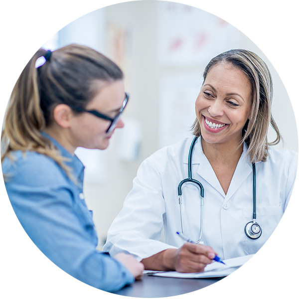 Two women, doctor and patient, reviewing paperwork